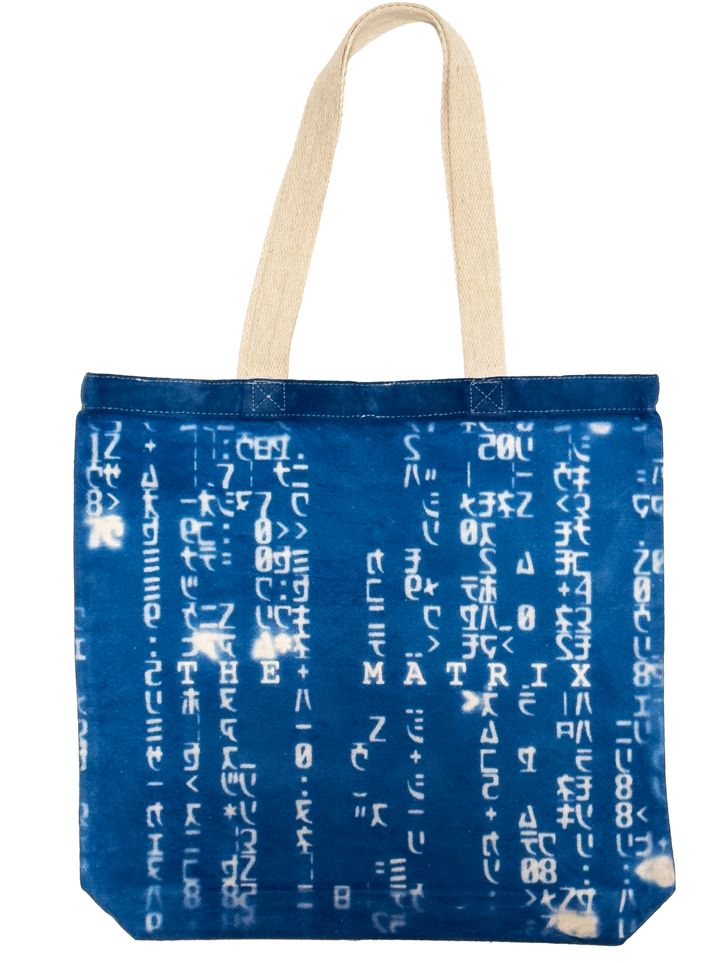 A blue fabric tote bag with white Matrix characters printed vertically across the front, featuring two beige canvas shoulder straps.