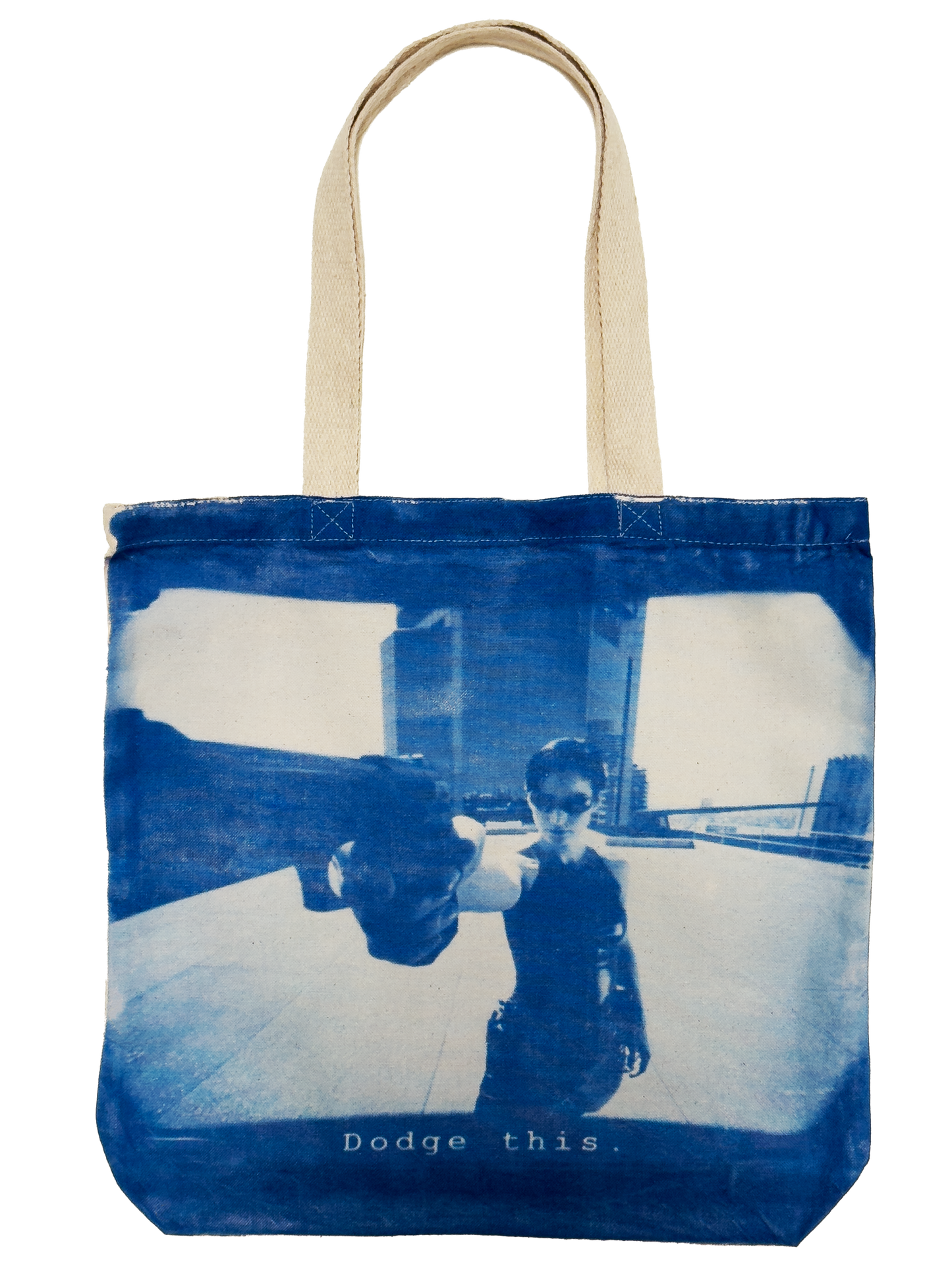 Trinity from The Matrix poiniting at the screen with a gun saying "Dodge This" on a cyanotype print tote bag